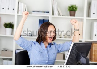 stock-photo-happy-businesswoman-with-clenched-fists-screaming-while-looking-at-computer-in-office-143837233